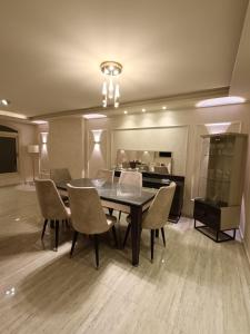a dining room with a table and chairs at LUXURY APARTMENT Dokki in Cairo