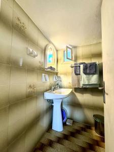 a bathroom with a white sink in a room at Stories of Samos beach studio 1 in Kámpos
