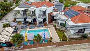 an overhead view of a house with a swimming pool at Sea Pearl Luxury Apartments in Nea Vrasna