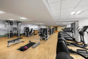 a gym with rows of treadmills and exercise machines at Renaissance Denver Hotel & Conference Center in Denver