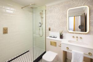a bathroom with a sink and a shower at Holiday Inn London Oxford Circus, an IHG Hotel in London