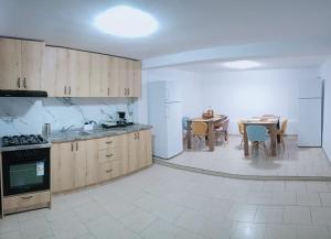 a kitchen with wooden cabinets and a table and chairs at Pam Dubova Holiday in Dubova