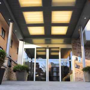 a building with glass doors and lights on the ceiling at Casino Hotel in Koksijde