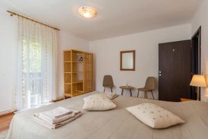 a bedroom with a large bed with two pillows on it at Cabana ZIP in Zărneşti