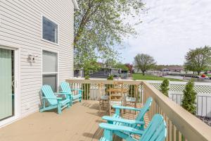 una terraza con sillas azules y mesas en una casa en Port Clinton Retreat with Lake Access and Dock!, en Port Clinton