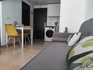 a living room with a couch and a table at Javea's Port apartment in Jávea