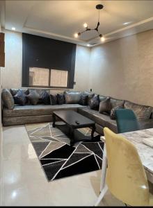 a living room with a couch and a table at Nador Jadid Hay AL Matar 10 6 in Nador