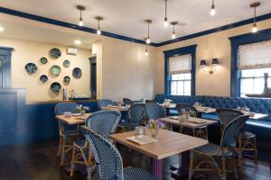 a dining room with wooden tables and chairs at The Christopher, The Edgartown Collection in Edgartown