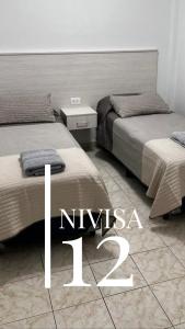 Edificio NIVISA客房内的一张或多张床位