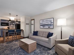 a living room with a couch and a table at Candlewood Suites Radcliff - Fort Knox by IHG in Radcliff