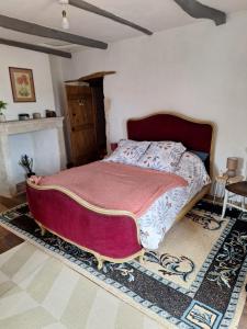 a bedroom with a large bed in a room at La maison du Donjon in Airvault