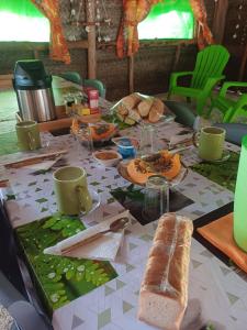 a table with food and bread on top of it at Poemanahere island camping à Maupiti in Te-Fare-Arii