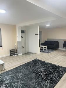 a living room with a couch and a rug at studio flat in Spinney Hill