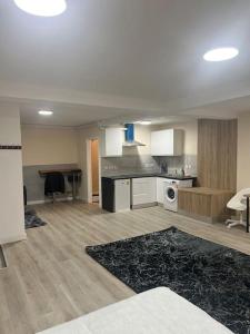 an empty kitchen and living room with a table at studio flat in Spinney Hill