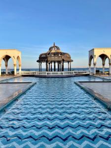 a building with a gazebo in the middle of water at Apartment with private Beach in Sahl Hasheesh in Hurghada