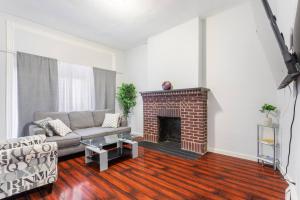a living room with a couch and a fireplace at Perfect for Relaxation cozy room 6 mins Newark Airport Rm A in Newark