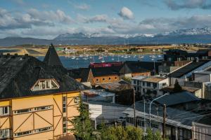 a city with buildings and a harbor with mountains at Gente del Sur - Urbano Centro in Ushuaia