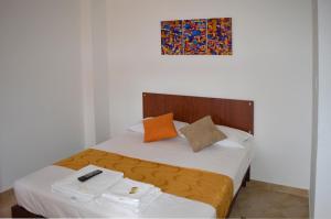 A bed or beds in a room at Hotel Tropico Real Mesitas