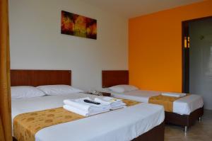 Postel nebo postele na pokoji v ubytování Hotel Tropico Real Mesitas