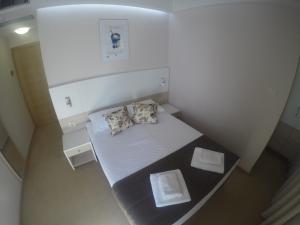 a small room with a bed and two pillows at Guest House Neho in Cres
