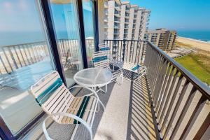 a balcony with chairs and a table and the ocean at Sea Colony --- 1004S Edgewater House Road in Bethany Beach