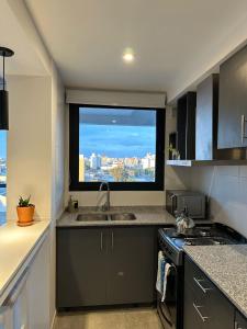 a kitchen with a window with a view of the city at Departamento Paso 3244 in Mar del Plata