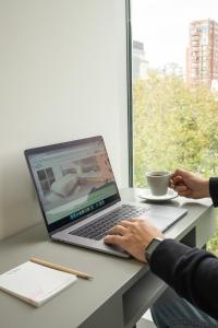 a person sitting at a desk with a laptop computer at Vain Boutique Hotel in Buenos Aires