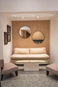 a living room with a bed and a mirror at Vain Boutique Hotel in Buenos Aires
