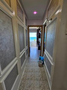 a hallway of a house with a door and the ocean at la belle vue tanger R in Tangier