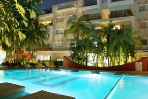 a large swimming pool in front of a building at Caribe Grand Dream in Playa del Carmen