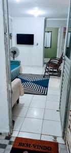 a living room with two rugs on the floor at Casa de temporada em Petrolina-pe in Petrolina