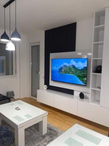 a living room with a flat screen tv on a wall at Bela in Kumanovo