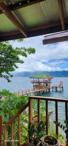 a view of the ocean from a deck with a pier at CHUE&LARRY'S BEACHSIDE HOMESTAY in Libagon