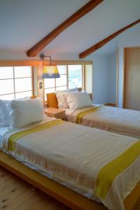 2 nebeneinander sitzende Betten in einem Schlafzimmer in der Unterkunft Hanakaijichi - Vacation STAY 74775v in Wajima