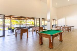 a pool table in a room with tables and windows at Vista Linda Eco Resort Carneiros in Tamandaré
