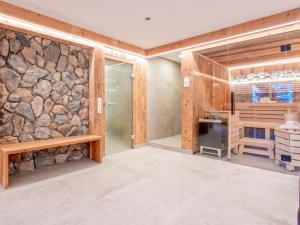 a large room with a stone wall and a desk at Haus Sonnberg in Hinterthal