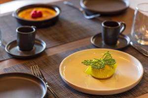 a table with a plate with a dessert on it at DIAGONAL HOTEL in Tangier