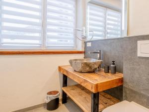 a bathroom with a bowl sink on a wooden counter at Haus Sonnberg in Hinterthal