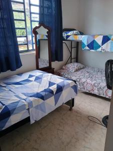 1 dormitorio con 2 literas y espejo en casa turística La Alameda, en Carmen de Apicalá
