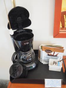 a coffee maker sitting on top of a counter at Wild Rivers Motorlodge in Brookings