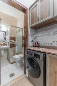 a kitchen with a washing machine in a bathroom at old town apartment in Aqaba