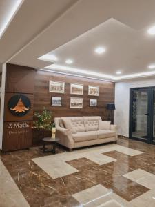 a living room with a couch and a wall at Happy Dreams Spa Zlatibor in Zlatibor