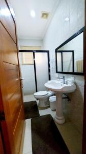 a bathroom with a sink and a toilet at Liturs house in Bacolod