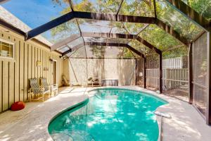 a swimming pool in a house with a large window at 13 Green Winged Teal in Fernandina Beach