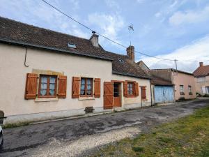 an old house with wooden shuttered windows on a street at Maison de Bourg Rénovée avec Jardin et Salle de Jeux à Levroux - FR-1-591-204 in Levroux