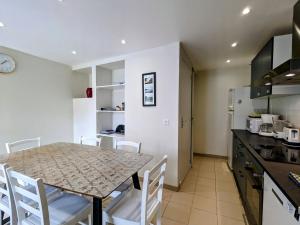 a kitchen and dining room with a table and chairs at Maison de Bourg Rénovée avec Jardin et Salle de Jeux à Levroux - FR-1-591-204 in Levroux +13 photos