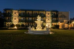 a large building with a fountain in front of a building at GRAND HOTEL SERGIJO RESIDENCE superior Adult only luxury boutique hotel in Piešťany