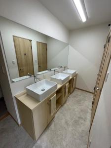 a bathroom with two sinks and a large mirror at Koko in Fujikawaguchiko