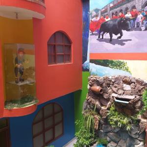 a lego house with a cow on the ground at Hotel karol in Ayacucho