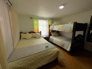 1 Schlafzimmer mit 2 Etagenbetten und einem Fenster in der Unterkunft Anhyali Hospedaje in Villa de Leyva